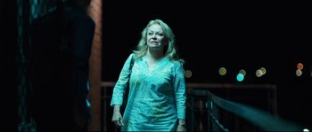 Movie still from “Animal Kingdom” (2010), directed by David Michôd – A woman is standing on a bridge at night; Medium shot, Over the shoulder angle
