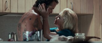 Movie still from “Animal Kingdom” (2010), directed by David Michôd – A man and a woman in a kitchen; Close Up shot, Overhead angle