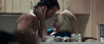Movie still from “Animal Kingdom” (2010), directed by David Michôd – A man and a woman laying on a table; Close Up shot, Over the shoulder angle