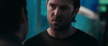 Movie still from “Animal Kingdom” (2010), directed by David Michôd – A person wearing a black shirt; Close Up shot, Over the shoulder angle