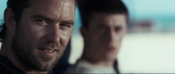 Movie still from “Animal Kingdom” (2010), directed by David Michôd – A man with a goatee is looking at the camera; Close Up shot, Over the shoulder angle