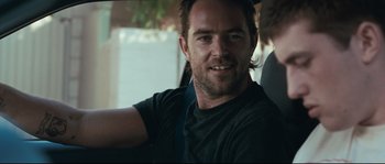 Movie still from “Animal Kingdom” (2010), directed by David Michôd – A person sitting in a car; Close Up shot, Over the shoulder angle