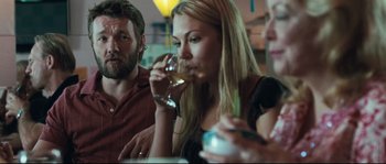 Movie still from “Animal Kingdom” (2010), directed by David Michôd – A group of people sitting at a table drinking wine; Close Up shot, Over the shoulder angle