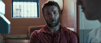 Movie still from “Animal Kingdom” (2010), directed by David Michôd – A person with a beard wearing a red shirt; Close Up shot, Over the shoulder angle