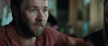 Movie still from “Animal Kingdom” (2010), directed by David Michôd – A person wearing a red shirt; Close Up shot, Over the shoulder angle