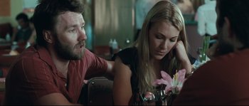 Movie still from “Animal Kingdom” (2010), directed by David Michôd – A man and a woman sitting at a table with flowers; Close Up shot, Over the shoulder angle