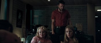 Movie still from “Animal Kingdom” (2010), directed by David Michôd – Two women and a man standing in a living room; Medium shot, Low angle