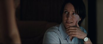 Movie still from “Animal Kingdom” (2010), directed by David Michôd – A woman sitting on a couch with her hand under her chin; Close Up shot, Over the shoulder angle