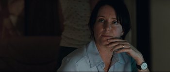 Movie still from “Animal Kingdom” (2010), directed by David Michôd – A woman sitting in front of a window with her hand to her face; Close Up shot, Over the shoulder angle