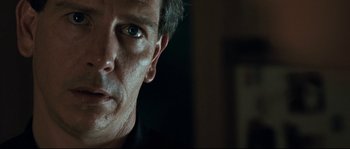 Movie still from “Animal Kingdom” (2010), directed by David Michôd – A man's face in a dark room; Close Up shot, Over the shoulder angle