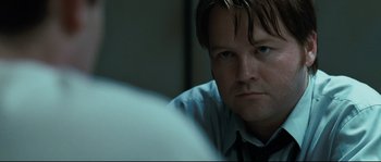 Movie still from “Animal Kingdom” (2010), directed by David Michôd – A person wearing a shirt and tie; Close Up shot, Over the shoulder angle