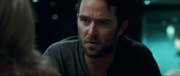 Movie still from “Animal Kingdom” (2010), directed by David Michôd – A person wearing a gray shirt; Close Up shot, Over the shoulder angle