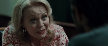 Movie still from “Animal Kingdom” (2010), directed by David Michôd – An older woman sitting in front of a man; Close Up shot, Over the shoulder angle