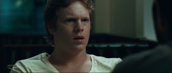 Movie still from “Animal Kingdom” (2010), directed by David Michôd – A young man is looking into the distance; Close Up shot, Over the shoulder angle