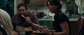 Movie still from “Animal Kingdom” (2010), directed by David Michôd – A man and a woman sitting at a dinner table; Medium shot, High angle