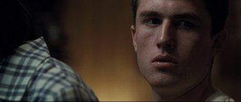 Movie still from “Animal Kingdom” (2010), directed by David Michôd – A man's face in a room; Close Up shot, Over the shoulder angle
