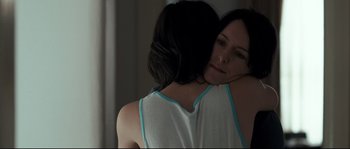 Movie still from “Animal Kingdom” (2010), directed by David Michôd – A woman hugging another woman in front of a mirror; Close Up shot, Over the shoulder angle