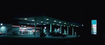Movie still from “Animal Kingdom” (2010), directed by David Michôd – A car parked at a gas station at night; Extreme Wide shot, Low angle