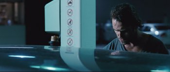 Movie still from “Animal Kingdom” (2010), directed by David Michôd – A man sitting in front of a computer monitor; Close Up shot, Low angle