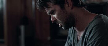 Movie still from “Animal Kingdom” (2010), directed by David Michôd – A person looking down at his face; Close Up shot, Over the shoulder angle