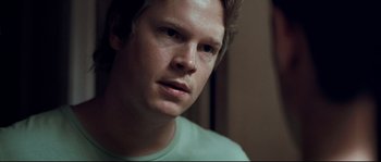 Movie still from “Animal Kingdom” (2010), directed by David Michôd – A person wearing a green shirt; Close Up shot, High angle
