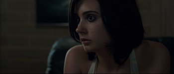 Movie still from “Animal Kingdom” (2010), directed by David Michôd – A person sitting down with her eyes wide open; Close Up shot, Low angle