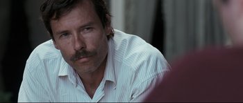 Movie still from “Animal Kingdom” (2010), directed by David Michôd – A person wearing a shirt; Close Up shot, Over the shoulder angle