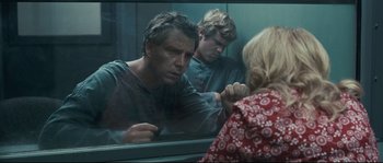 Movie still from “Animal Kingdom” (2010), directed by David Michôd – A man and a woman are reflected in a bathroom mirror; Medium shot, Over the shoulder angle