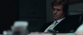 Movie still from “Animal Kingdom” (2010), directed by David Michôd – A person wearing a suit and tie; Close Up shot, Over the shoulder angle