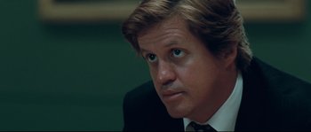 Movie still from “Animal Kingdom” (2010), directed by David Michôd – A person wearing a suit and tie; Close Up shot, Low angle