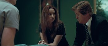 Movie still from “Animal Kingdom” (2010), directed by David Michôd – A woman with long hair sitting next to another woman; Medium shot, Over the shoulder angle