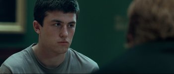 Movie still from “Animal Kingdom” (2010), directed by David Michôd – A young man is sitting in front of a computer screen; Close Up shot, Over the shoulder angle