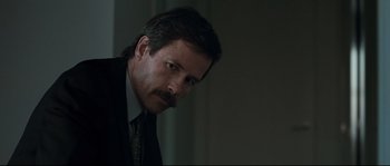 Movie still from “Animal Kingdom” (2010), directed by David Michôd – A person wearing a suit and tie; Close Up shot, Over the shoulder angle