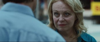 Movie still from “Animal Kingdom” (2010), directed by David Michôd – An older woman looking at the camera while standing next to a younger man; Close Up shot, Over the shoulder angle