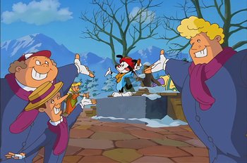 Movie still from “Animaniacs: Wakko's Wish” (1999), directed by Kirk Tingblad – A group of people standing in front of an animated character; Wide shot, Low angle