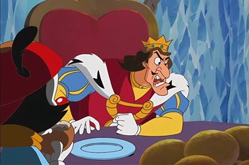 Movie still from “Animaniacs: Wakko's Wish” (1999), directed by Kirk Tingblad – A cartoon of a man in a crown with a knife in his mouth; Medium shot, Over the shoulder angle