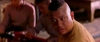 Movie still from “Anna and the King” (1999), directed by Andy Tennant – A person with a shaved head; Close Up shot, Low angle