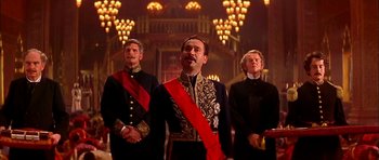 Movie still from “Anna and the King” (1999), directed by Andy Tennant – A group of men standing next to each other in a room; Medium shot, Low angle
