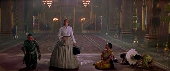 Movie still from “Anna and the King” (1999), directed by Andy Tennant – A woman in a long skirt and a woman in a yellow dress; Wide shot, Low angle