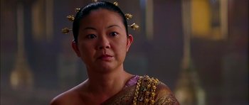 Movie still from “Anna and the King” (1999), directed by Andy Tennant – An asian woman wearing a gold headpiece; Close Up shot, Over the shoulder angle
