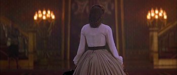 Movie still from “Anna and the King” (1999), directed by Andy Tennant – A woman in a long skirt and a white shirt; Medium shot, Over the shoulder angle