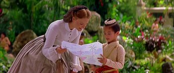 Movie still from “Anna and the King” (1999), directed by Andy Tennant – A woman and a child looking at a piece of paper; Medium shot, Over the shoulder angle