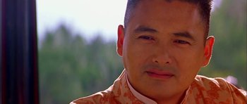 Movie still from “Anna and the King” (1999), directed by Andy Tennant – A person wearing a suit and tie; Close Up shot, Low angle