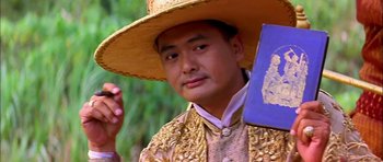 Movie still from “Anna and the King” (1999), directed by Andy Tennant – A man wearing a hat and holding a book in his hand; Close Up shot, Low angle