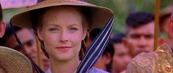 Movie still from “Anna and the King” (1999), directed by Andy Tennant – A person wearing a hat and holding an umbrella; Close Up shot, Over the shoulder angle