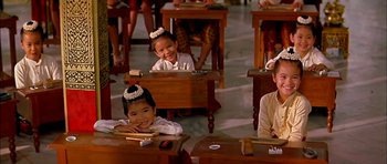 Movie still from “Anna and the King” (1999), directed by Andy Tennant – A group of children sitting at desks in a classroom; Medium shot, High angle