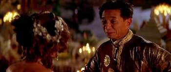 Movie still from “Anna and the King” (1999), directed by Andy Tennant – An older man in a red and gold jacket; Close Up shot, Over the shoulder angle