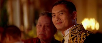 Movie still from “Anna and the King” (1999), directed by Andy Tennant – A man and a man in a suit and tie looking at the camera; Close Up shot, Over the shoulder angle