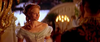 Movie still from “Anna and the King” (1999), directed by Andy Tennant – A woman in a white dress standing in front of candles; Close Up shot, Over the shoulder angle