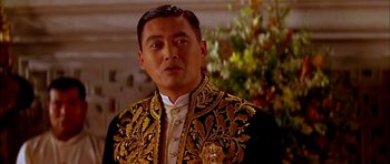 Movie still from “Anna and the King” (1999), directed by Andy Tennant – A person wearing a suit and tie; Close Up shot, Low angle